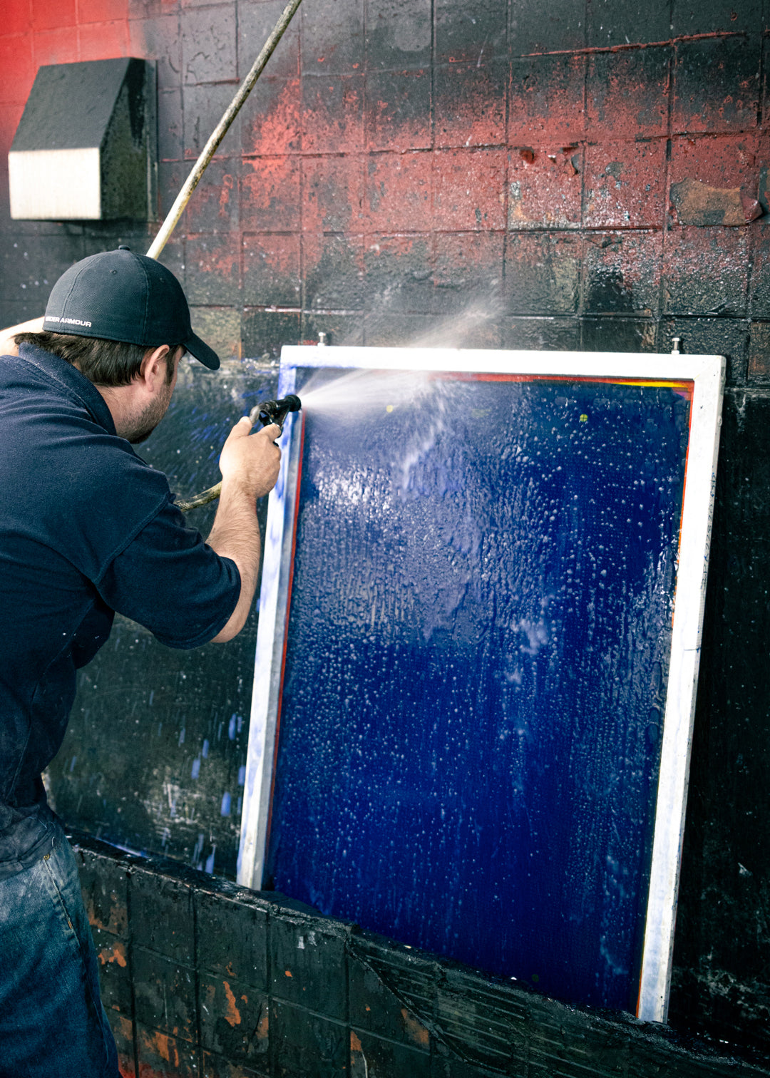 Silk screens being washed after use