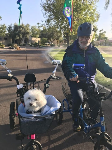 Two Liberty Trike riders out riding with a dog in the front basket