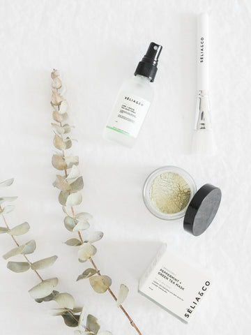 wellness products on white background with eucalyptus