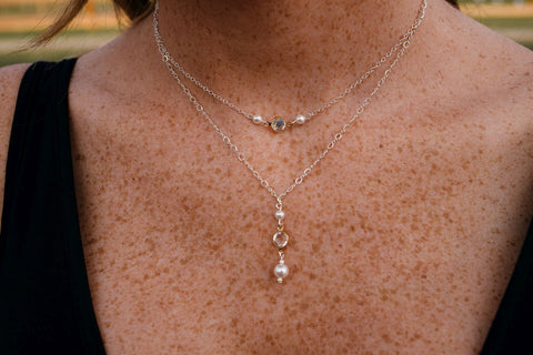 Two delicate necklaces layered 