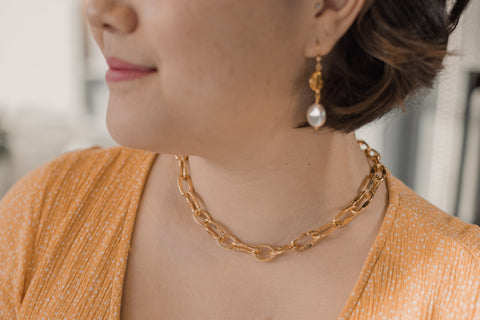 Woman wearing gold chain necklace