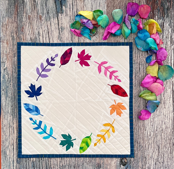 mini quilt with rainbow coloured leaves