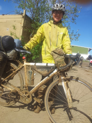 Bike and rider coated in mud, 100 miles south of Coldfoot on the Dalton Highway, Alaska