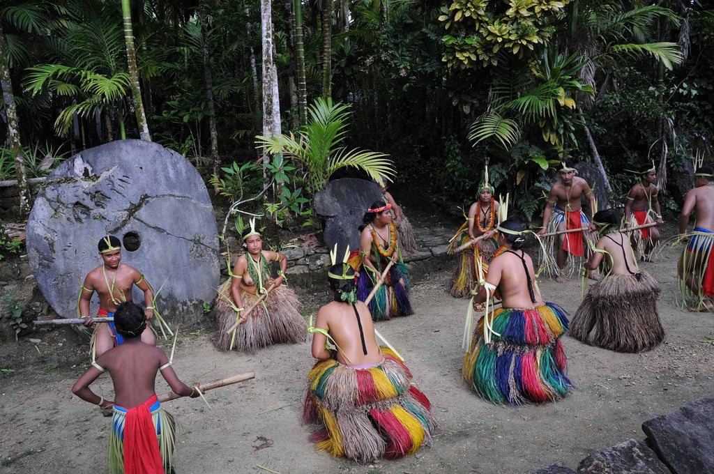 Traditional dancers in Yap Micronesia with stone money in background copyright Jean Rydberg Ikelite