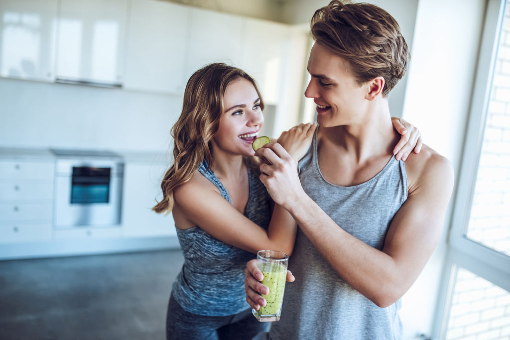 Couple eating food together in workout clothes