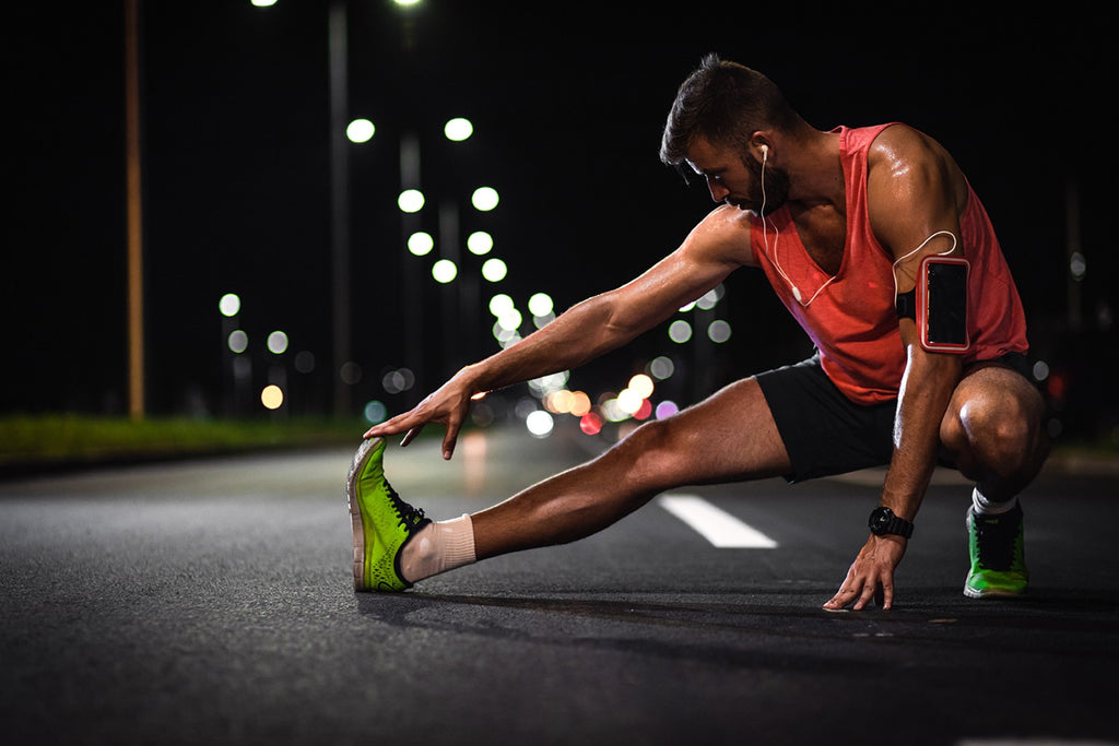 man stretching on the road