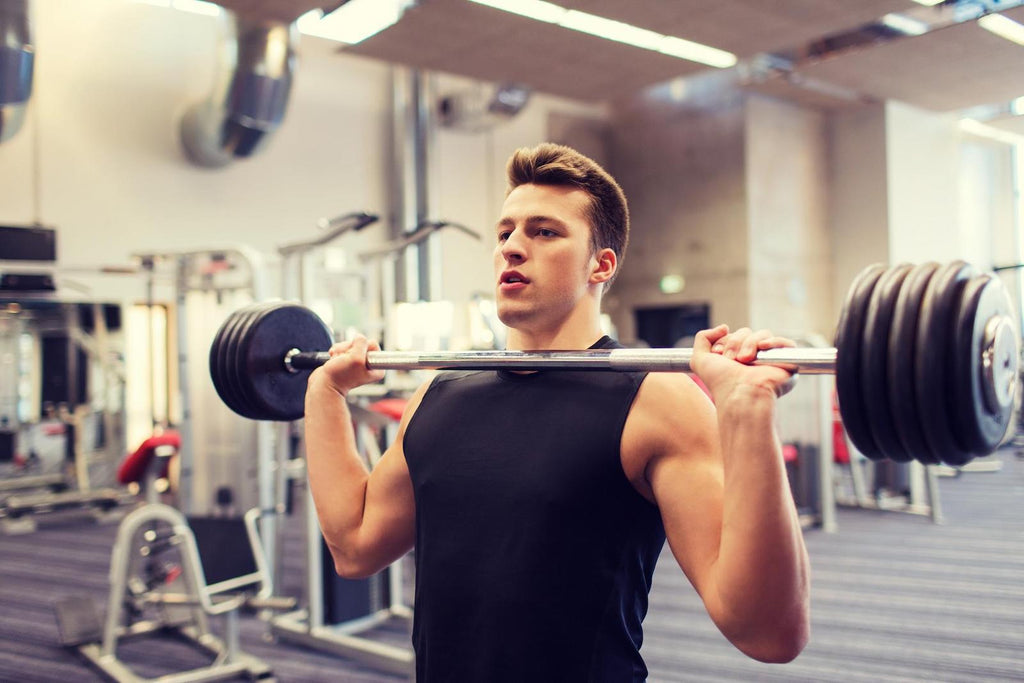 How to get stronger: Man doing barbell shoulder press
