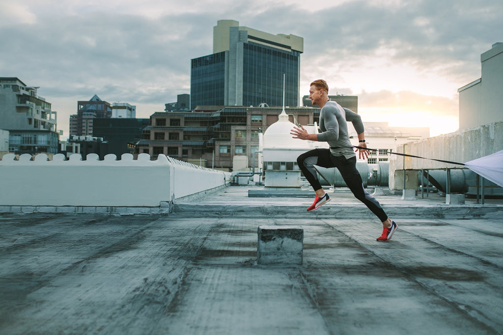 how to run faster: man running on rooftop