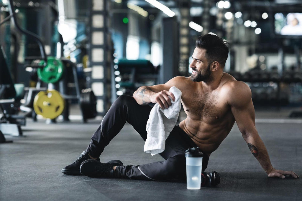 How to get stronger: Muscular man resting after workout