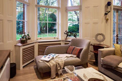 Chaise longue in front of bay window with garden view