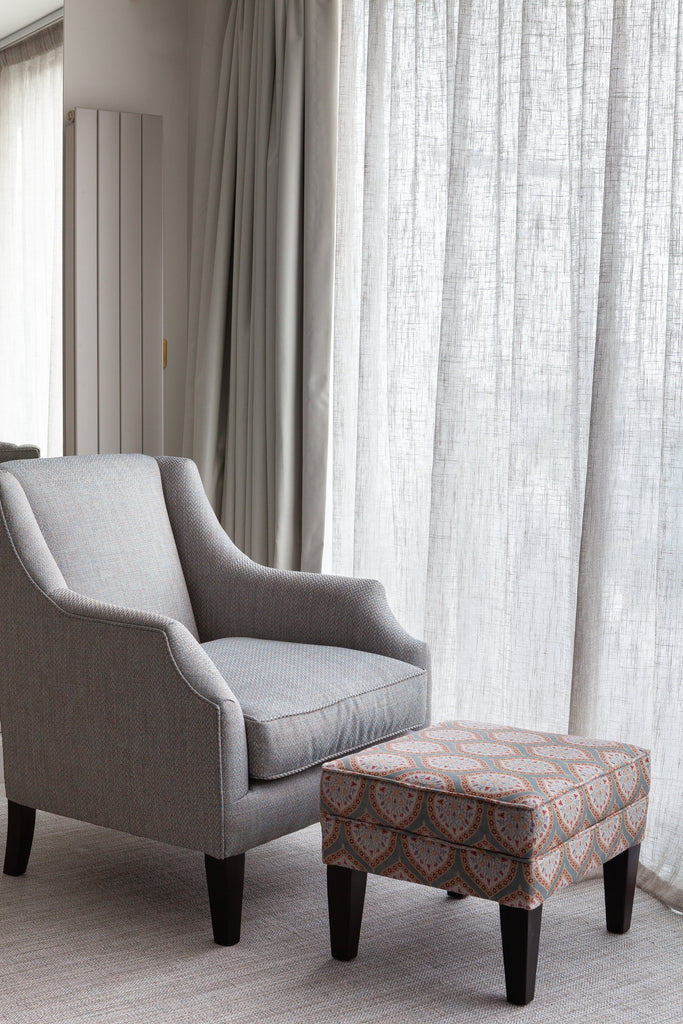 Relaxed chair with stool in master bedroom