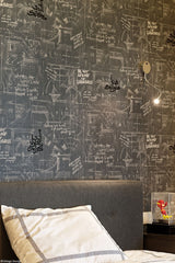 Wall in bedroom of one of the sons of the family, Andrew Martin wallpaper with Arabic calligraphy written on top.