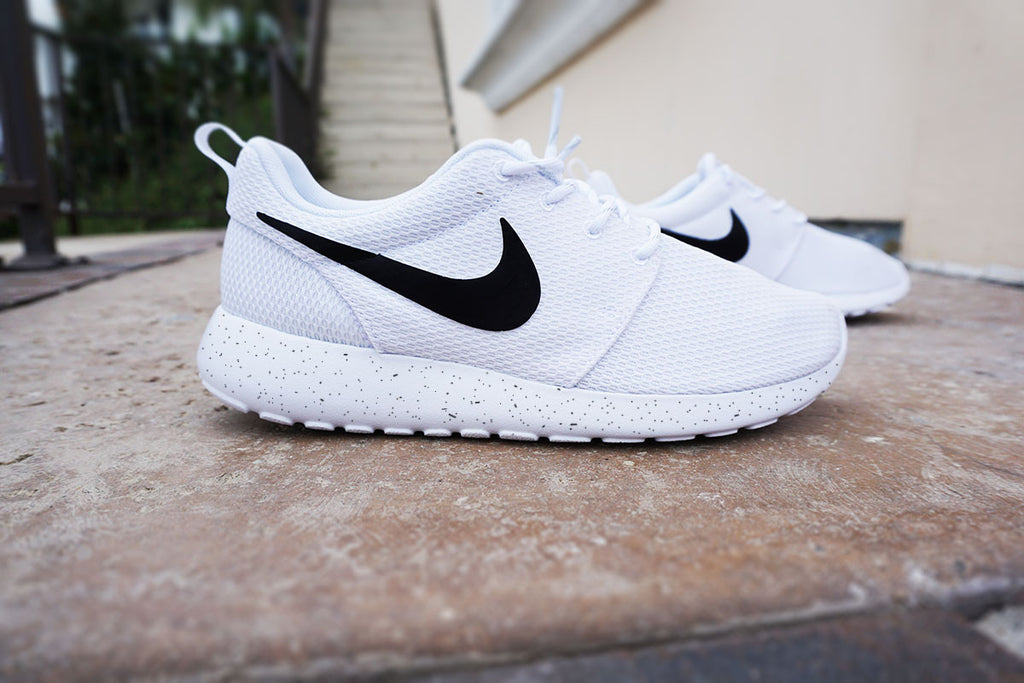 white shoes with black nike sign