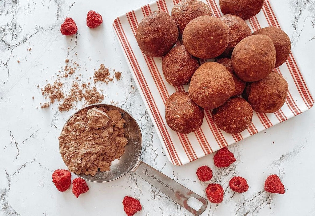 Chocolate Protein Balls With Frozen Rasberries Displayed On table