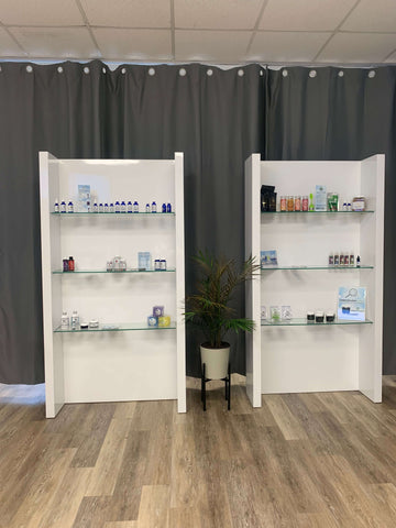 white store shelves with products displayed, gray background, wood floor 