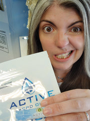 woman making silly face holding package close to camera