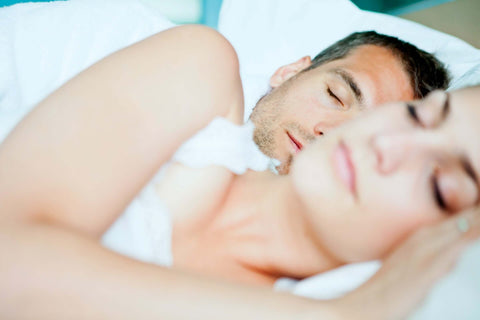 Couple sleeping deeply in bed