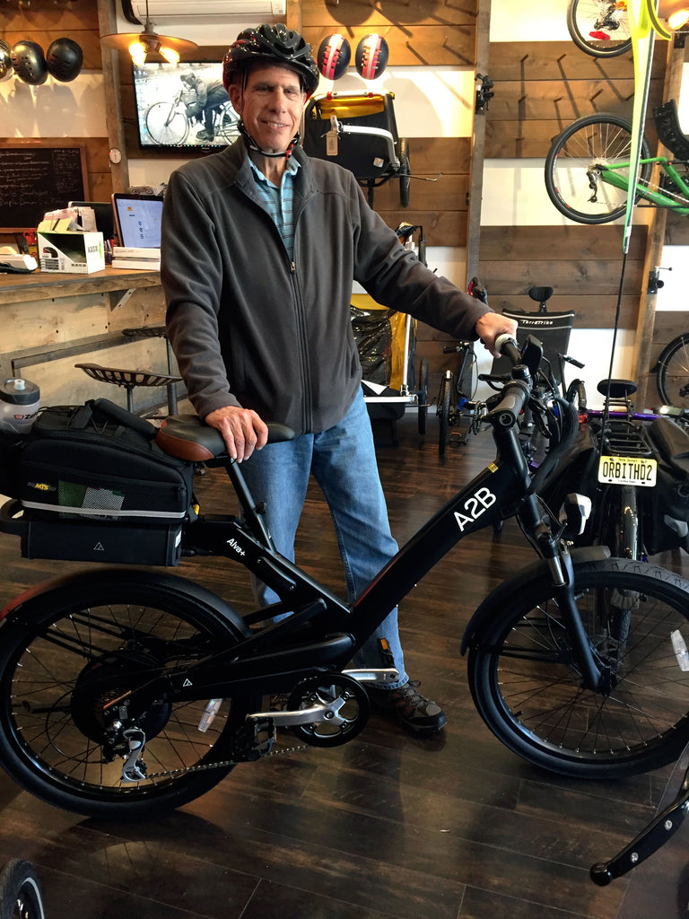 a happy A2B Alva+ e-bike owner