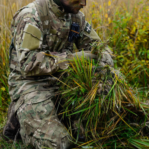 Soldier creating a Ghillie suit