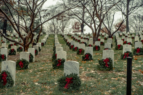 A cemetery with wreaths decorating its headstones