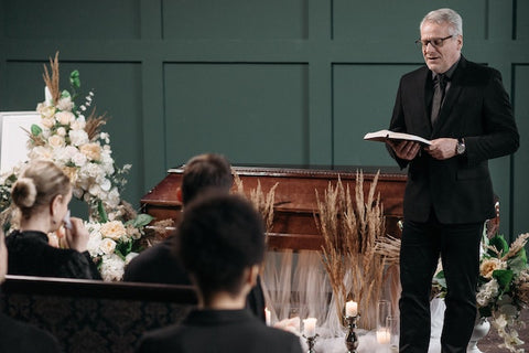 A pastor giving a sermon at a funeral 