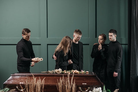 Funeral attendants paying last respects