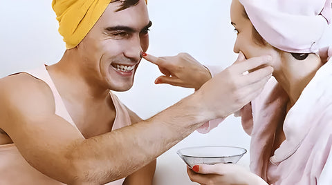 a young couple putting face masks on each other