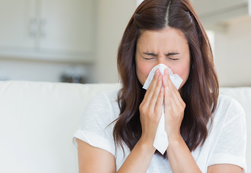 Woman sneezing