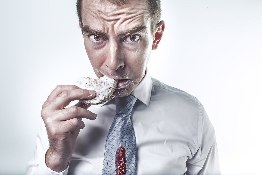 Hungry man eating unhealthy snack