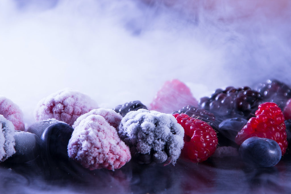 Frozen fruits and vegetables with purple background