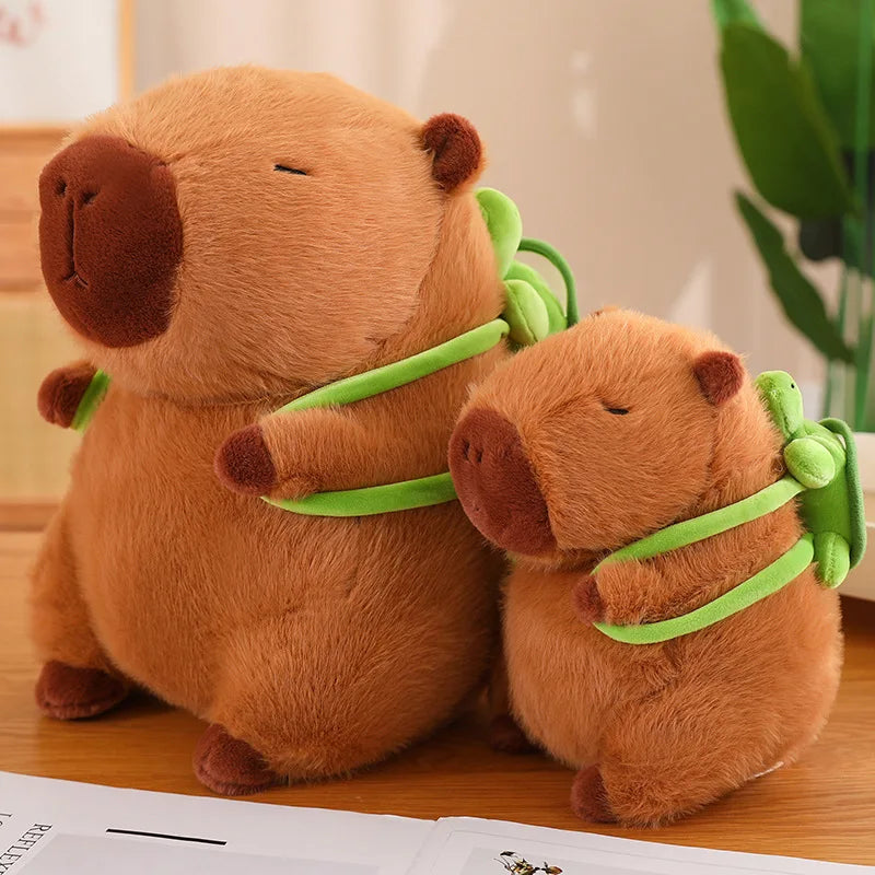 Two Brown Capybara Stuffed Plushie Toys with Green Backpacks