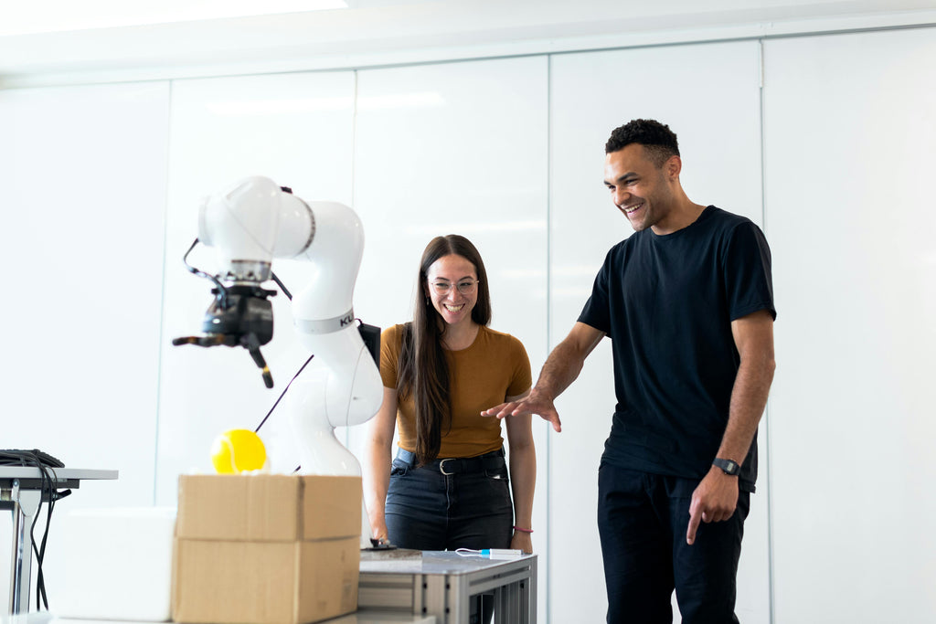 Man and Woman Using Machinery During Sample Prototype Stage