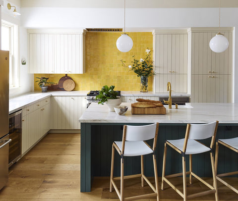 White overhang kitchen countertop yellow backsplash