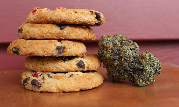 stack of weed cookies next to marijuana buds