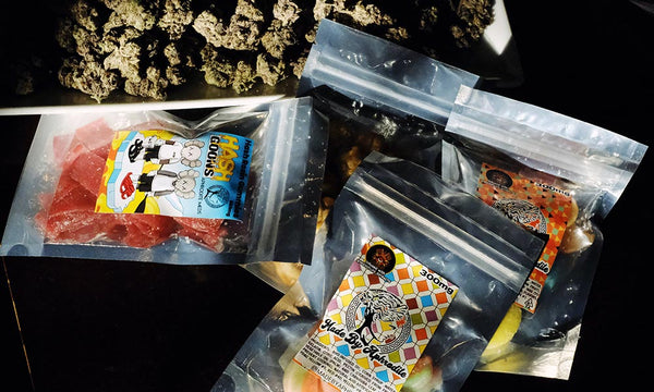 bags of thc gummies laying on top of cannabis flower