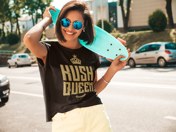 woman with penny board and weed shirt saying Kush Queen
