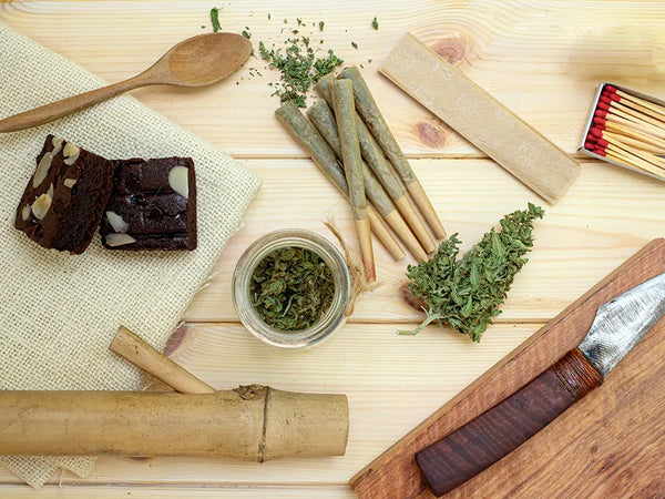 Cannabis paraphernalia, joints, rolling papers, brownies and more on a table