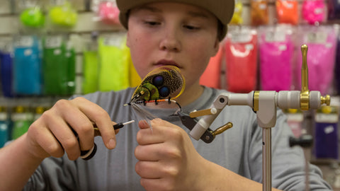 Boy tying a salmon fly