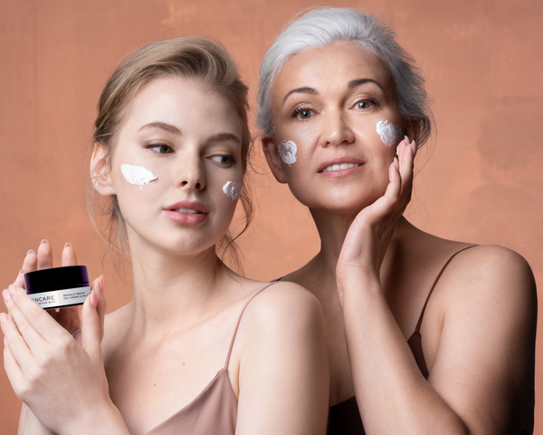 Beautiful Mother and Daughter applying rich moisturiser to their face