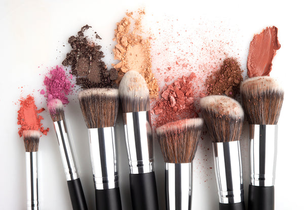 Many makeup brushes with different powders on them