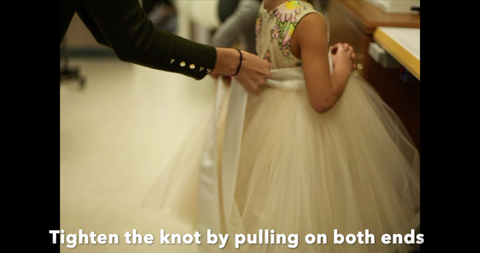 tying sashes on wedding dresses