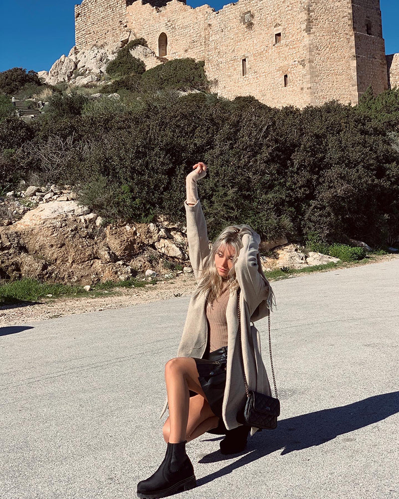 travel greece with local insider bella revas wearing otbt shoes near castle