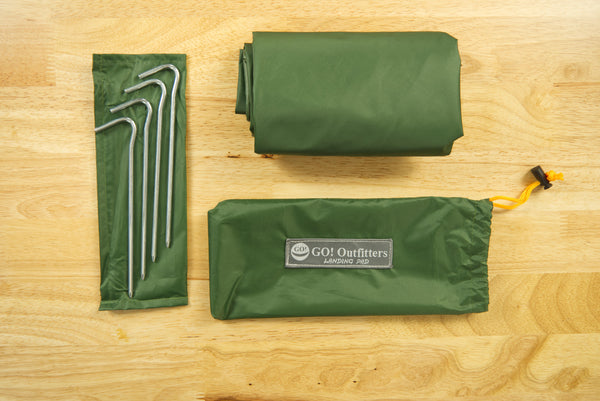 The Landing Pad includes four stakes and a water resistant stuff sack. It's perfect for your next hammock camping or tent camping trip!