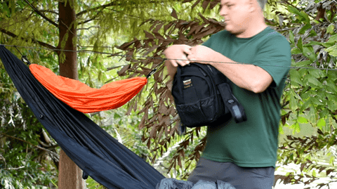 Large camera bag being put into the Hammock Gear Loft is shown here. Positioning the loops near each other and tightening up the built-in drawstrings will create a large hanging pouch that will hold a lot of your gear.