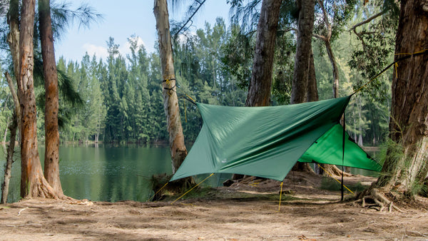 Photo of the Apex Camping Shelter Hammock Camping Tarp by Go Outfitters set up in storm mode