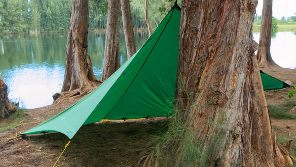 Apex Campgin Shelter set up in Cave Mode by tying a guy line to a tree.