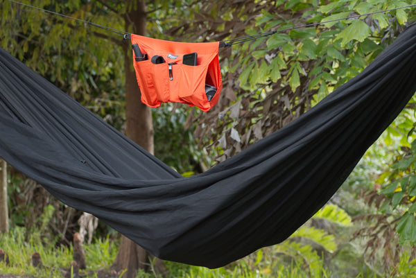 The Hammock Holdall can be positioned anywhere on the hammock ridgeline. It's stays in place with the included hooks and cord loops