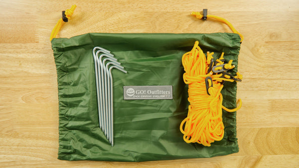The Apex Camping Shelter 2.0 includes six stakes, two 15' guy ropes with tensioners, six 8' guy ropes with tensioners, a storage bag for the stakes and ropes  and a water resistant Rapid Deployment Bag.