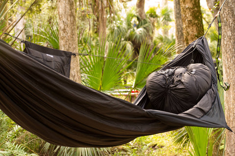 The Hammock Gear Loft is shown here at the foot end of a hammock. THis allows you to use wasted space when hammock camping.