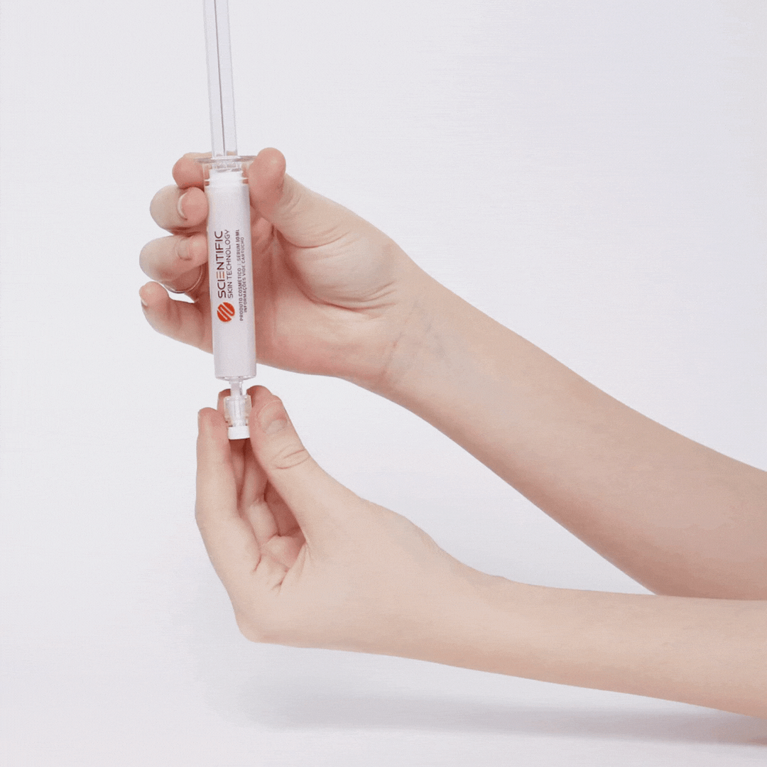 Hands assembling a white scientific syringe with a clear top on a light background.